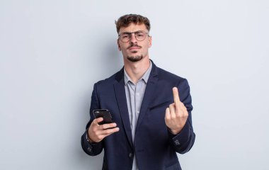 young handsome man feeling angry, annoyed, rebellious and aggressive. business concept