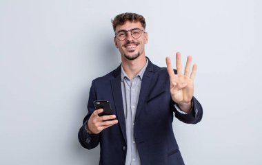 young handsome man smiling and looking friendly, showing number four. business concept