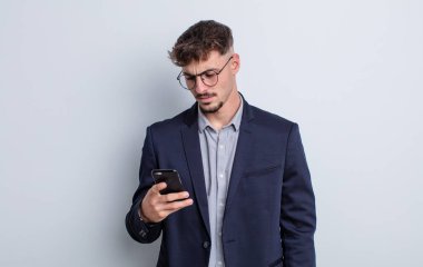 young handsome man feeling sad, upset or angry and looking to the side. business concept