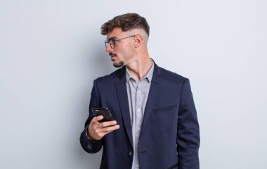 young handsome man on profile view thinking, imagining or daydreaming. business concept