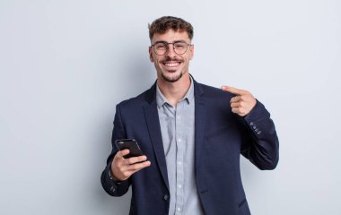 young handsome man smiling confidently pointing to own broad smile. business concept