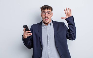 Genç yakışıklı adam ellerini havaya kaldırarak çığlık atıyor. iş kavramı