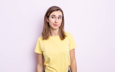 Genç güzel kız merak ediyor, mutlu düşünceler ve fikirler düşünüyor, hayal kuruyor, kenarda yer arıyor.