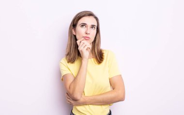 Genç güzel kız düşünüyor, kuşkulu ve şaşkın hissediyor, farklı seçeneklerle, hangi kararı vereceğini merak ediyor.