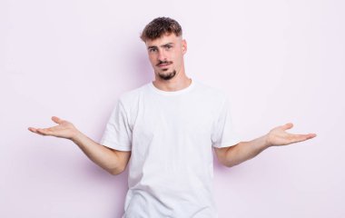 Şaşkın, şaşkın ve stresli görünen genç bir adam. Farklı seçenekler arasında merak ediyor. Belirsiz hissediyor.