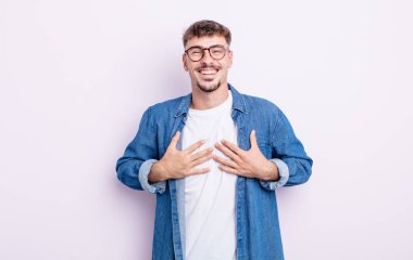 Genç yakışıklı adam mutlu görünüyor, şaşırmış, gururlu ve heyecanlı, kendini gösteriyor.