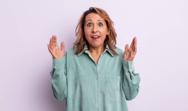 Orta yaşlı kadın şaşkın ve şaşkın bakıyor, inanılmaz bir şey fark ettiğinde çene şaşkın