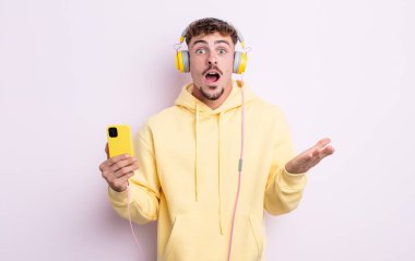 Genç ve yakışıklı bir adam şok olmuş ve şaşırmış hissediyor. müzik konsepti