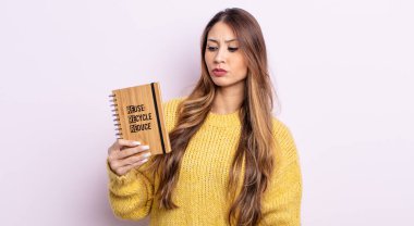 Asyalı güzel kadın üzgün, üzgün ya da kızgın hissediyor ve yan tarafa bakıyor. Geri dönüşüm kavramı