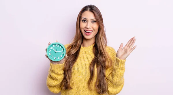 アジア系の可愛い女性は何か信じられないほどの幸せと驚きを感じる 目覚まし時計のコンセプト — ストック写真