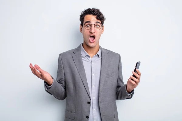 Hispanic Handsome Man Amazed Shocked Astonished Unbelievable Surprise Business Phone — Stock Photo, Image