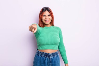 Genç İspanyol kadın kameraya tatmin olmuş, kendinden emin, dost canlısı bir gülümsemeyle bakıyor ve seni seçiyor.