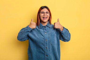 Genç İspanyol kadın gülümsüyor. Mutlu, pozitif, kendinden emin ve başarılı görünüyor.