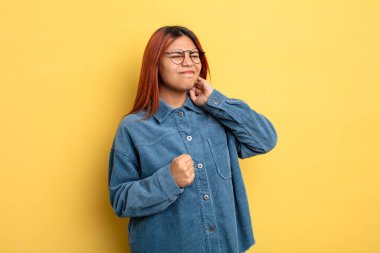 Genç İspanyol kadın stresli, hayal kırıklığına uğramış ve yorgun hissediyordu. Endişeli ve sorunlu bir bakışla boynunu ovuyordu.