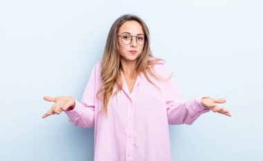 pretty caucasian woman feeling clueless and confused, having no idea, absolutely puzzled with a dumb or foolish look