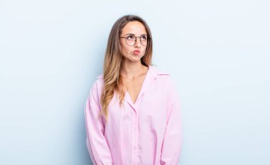 pretty caucasian woman looking puzzled and confused, wondering or trying to solve a problem or thinking