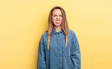pretty caucasian woman feeling disgusted and irritated, sticking tongue out, disliking something nasty and yucky