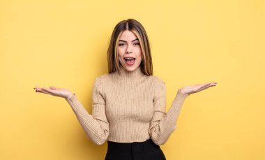 pretty caucasian woman feeling happy, excited, surprised or shocked, smiling and astonished at something unbelievable
