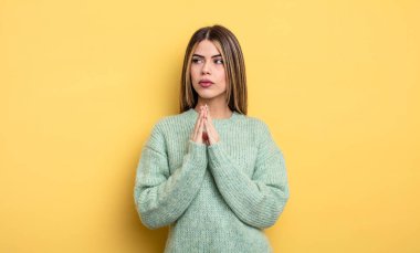 pretty caucasian woman feeling proud, mischievous and arrogant while scheming an evil plan or thinking of a trick