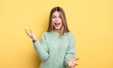 pretty caucasian woman feeling happy, astonished, lucky and surprised, like saying omg seriously? Unbelievable