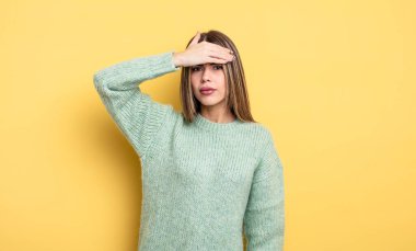 pretty caucasian woman panicking over a forgotten deadline, feeling stressed, having to cover up a mess or mistake
