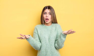 pretty caucasian woman open-mouthed and amazed, shocked and astonished with an unbelievable surprise