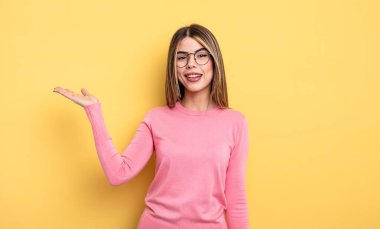 pretty caucasian woman feeling happy, surprised and cheerful, smiling with positive attitude, realizing a solution or idea
