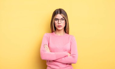 pretty caucasian woman feeling displeased and disappointed, looking serious, annoyed and angry with crossed arms