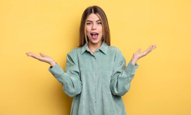 pretty caucasian woman feeling happy, excited, surprised or shocked, smiling and astonished at something unbelievable