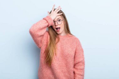 caucasian red hair woman raising palm to forehead thinking oops, after making a stupid mistake or remembering, feeling dumb