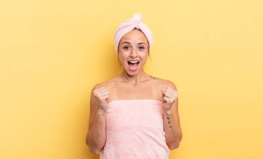 pretty woman feeling shocked,laughing and celebrating success. shower and beauty concept