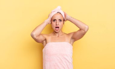 pretty woman feeling stressed, anxious or scared, with hands on head. shower and beauty concept