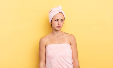 pretty woman feeling sad, upset or angry and looking to the side. shower and beauty concept