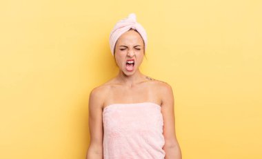 pretty woman shouting aggressively, looking very angry. shower and beauty concept