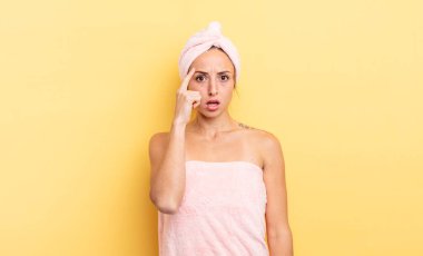 pretty woman looking surprised, realizing a new thought, idea or concept. shower and beauty concept