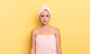 pretty woman looking puzzled and confused. shower and beauty concept