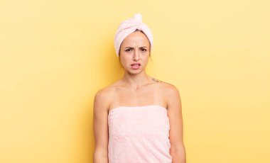 pretty woman feeling puzzled and confused. shower and beauty concept