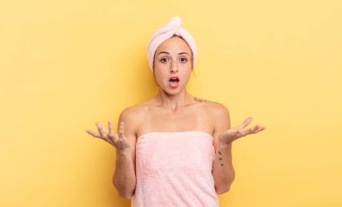 pretty woman feeling extremely shocked and surprised. shower and beauty concept
