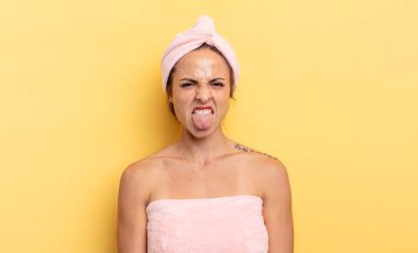pretty woman feeling disgusted and irritated and tongue out. shower and beauty concept