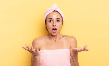 pretty woman feeling extremely shocked and surprised. shower and beauty concept