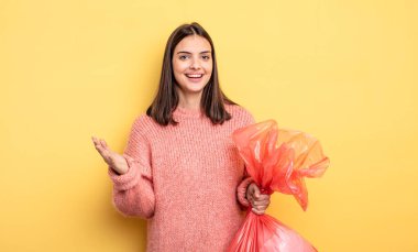 pretty woman feeling happy, surprised realizing a solution or idea. trash bag concept