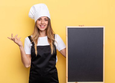 chef woman feeling happy, surprised realizing a solution or idea. blackboard menu concept
