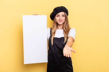 woman artist smiling happily with friendly and  offering and showing a concept empty canvas concept