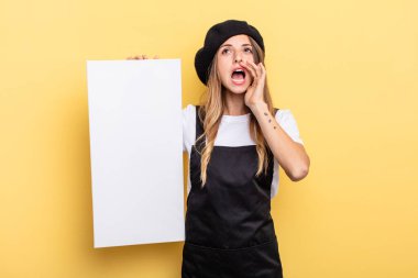 woman artist feeling happy,giving a big shout out with hands next to mouth empty canvas concept