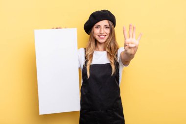 woman artist smiling and looking friendly, showing number four empty canvas concept