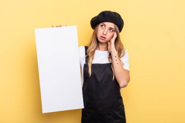 woman artist feeling bored, frustrated and sleepy after a tiresome empty canvas concept