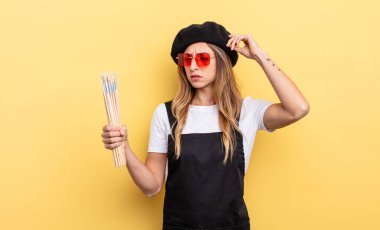 artist painter smiling happily and daydreaming or doubting