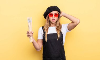 artist painter feeling stressed, anxious or scared, with hands on head