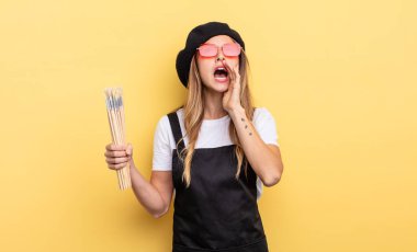 artist painter feeling happy,giving a big shout out with hands next to mouth