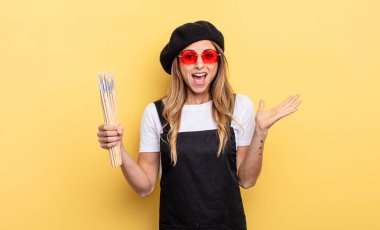 artist painter feeling happy and astonished at something unbelievable